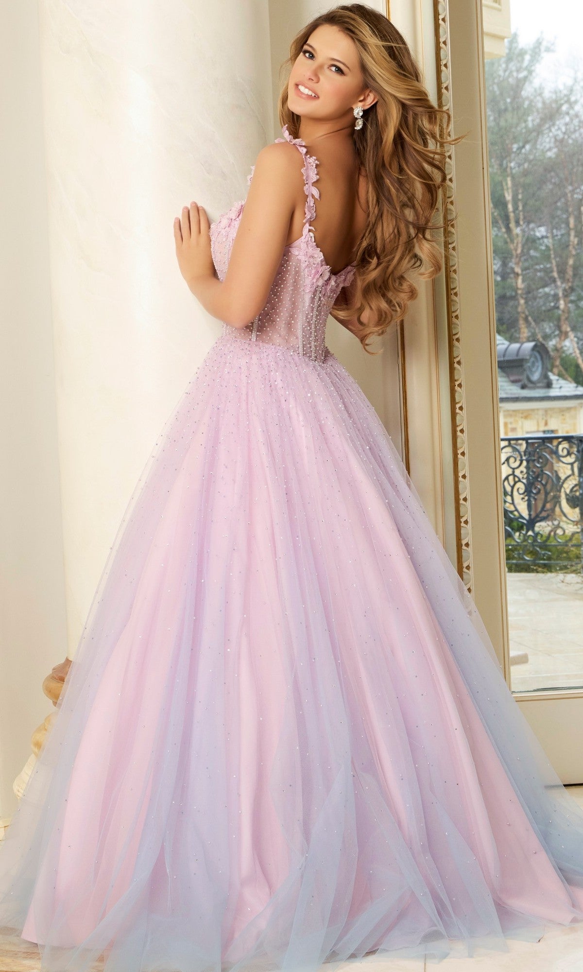 A woman in the Jovani 47305 Long Prom Dress, featuring a pink hue and a corset bodice.